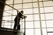 A businessman looking over balcony railings