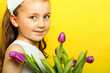 smiling beautiful  young girl with tulips at spring
