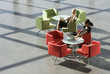 Two businesswomen sitting at tables in an office building