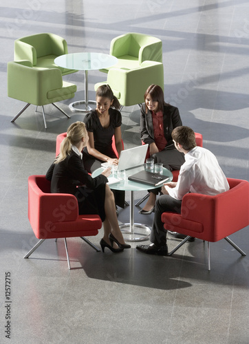 Photo: A group of four business colleagues holding an informal meeting A group of four business colleagues holding an informal meeting