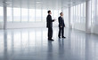 A letting agent showing a businessman around an empty office