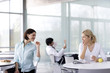 Two women gossiping over lunch in an office canteen