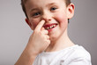 Little boy picking his nose