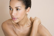 A young woman massaging her shoulder