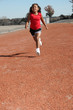 Adorable five year old African American Girl on school track.