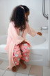 Adorable five year old African American Girl drawing bath.