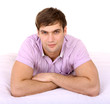 Attractive man on white sheet.