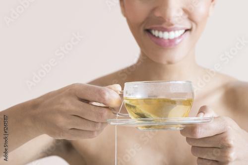 Photo: A woman drinking a cup of herbal tea A woman drinking a cup of herbal tea