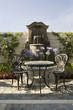 Table and Chairs in Front of Fountain on Patio