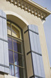 Wooden Shutters beside Arched Window