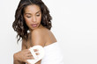 A woman buffing her skin with an exfoliating mitt
