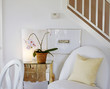 White Upholstered Chair by Side Table with Mirrored Front