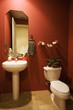 Front view of a sink and a toilet in a small washroom