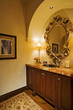 Side view of a sink under the mirror in an illuminated washroom