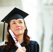 Young female graduate looking at copyspace