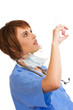 Foto: Attractive young Caucasian female doctor checking syringe Attractive young Caucasian female doctor checking syringe