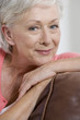 A senior woman sitting on a sofa
