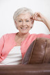 A senior woman sitting on a sofa