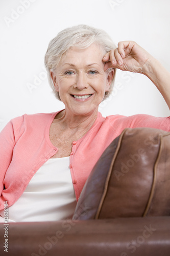 Photo: A senior woman sitting on a sofa A senior woman sitting on a sofa