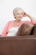 A senior woman sitting on a sofa