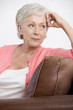 A senior woman sitting on a sofa