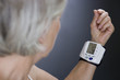 A senior woman with a heart rate monitor on her wrist