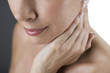 A woman touching her neck