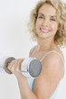 A middle-aged woman working out with free weights