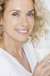 A middle-aged woman holding a glass of milk