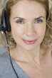 A middle aged woman wearing a headset