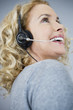 A middle aged woman wearing a headset