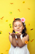 smiling beautiful  young girl with falling flowers at spring