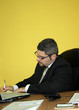 Young businessman writing at desk