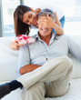 Woman covering her husband's eyes to surprise him