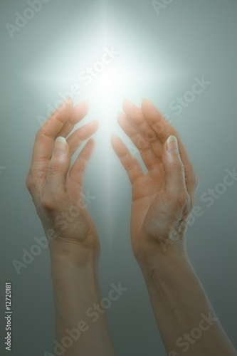 Hands receiving beautiful white healing energy