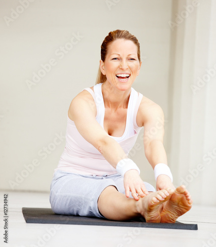 Photo: Portrait of smiling fit mature female working out Portrait of smiling fit mature female working out