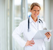 Photo: Smiling successful mature female doctor holding Smiling successful mature female doctor holding