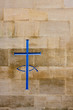 Engraving of a cross and fish in a stone wall
