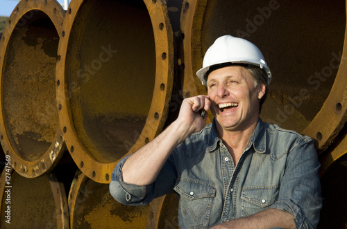 Photo: happy construction worker on cellphone happy construction worker on cellphone