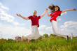 Happy Young Couple - team is jumping Happy Young Couple - team is jumping