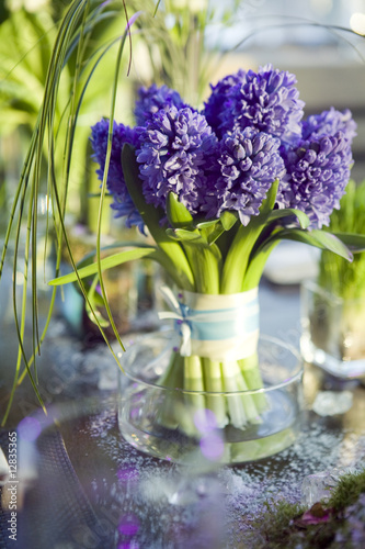 Photo: decoration of dining table. bouquet of hyacinth in vase of gl decoration of dining table. bouquet of hyacinth in vase of gl
