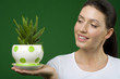 Photo: Woman holding aloe plant Woman holding aloe plant