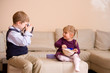 Boy taking picture of his sister