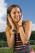 Beautiful Girl Listening Music with Auriculars Outdoors Beautiful Girl Listening Music with Auriculars Outdoors