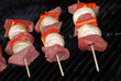 Uncooked beef kabobs on a barbecue  grill
