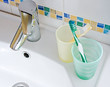 Photo: Yellow and green toobrushes on a bathroom sink Yellow and green toobrushes on a bathroom sink