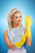Beautiful happy housewife with rubber gloves
