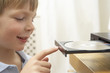 Photo: Young Boy Closing DVD Player With Finger Young Boy Closing DVD Player With Finger