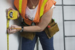 View of a woman using tape measure.