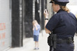 Foto: Woman police officer talking on hand mike. Woman police officer talking on hand mike.